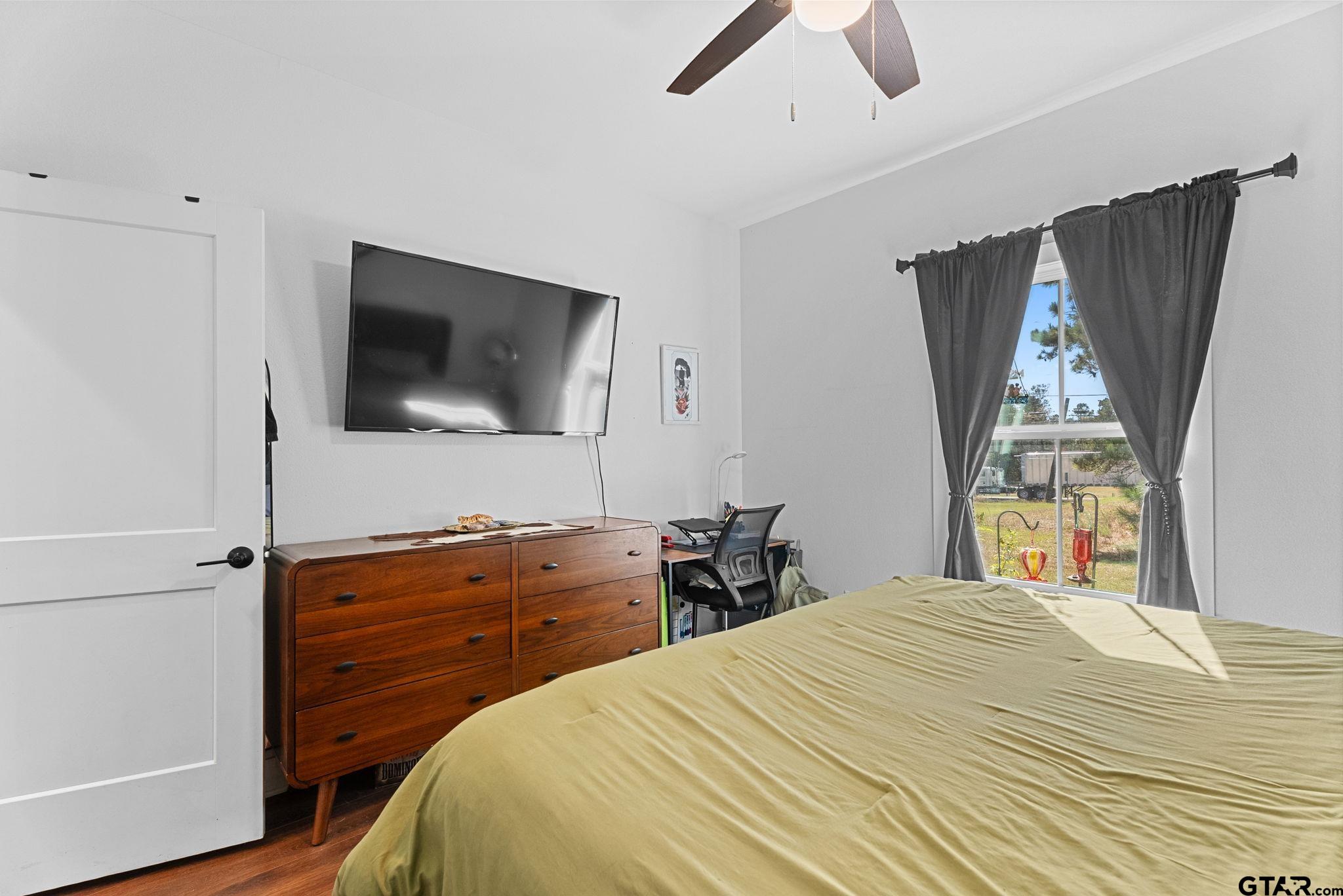 10374 Highway 204 Cushing, TX 75760 - Photo 19 of 28 a bedroom with a bed and a flat screen tv