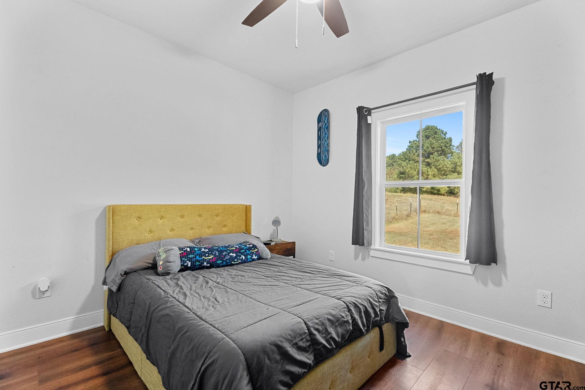 10374 Highway 204 Cushing, TX 75760 - Photo 21 of 28 a bedroom with a bed and a window