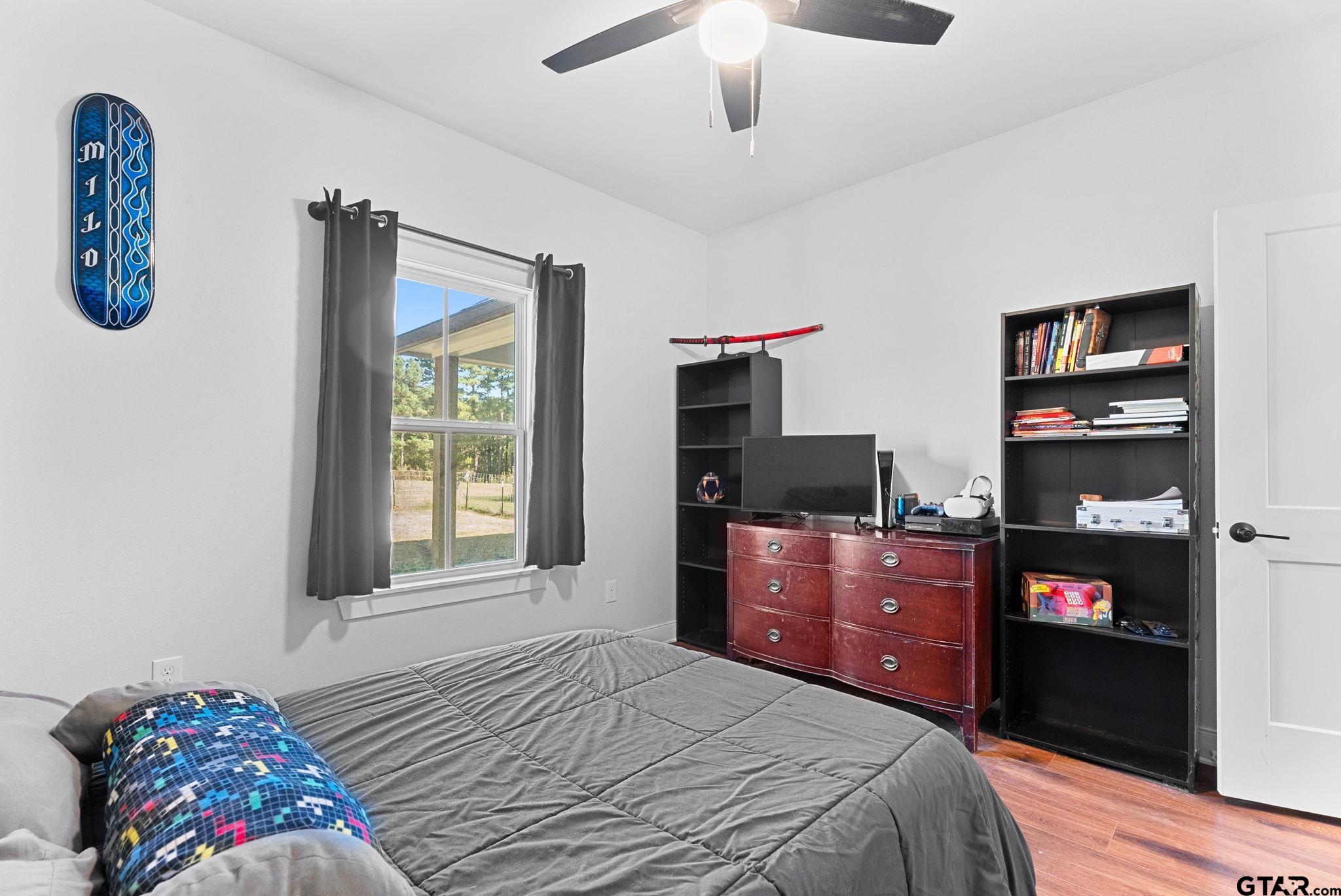 10374 Highway 204 Cushing, TX 75760 - Photo 22 of 28 a bedroom with a bed and a dresser