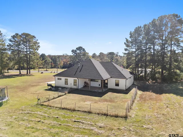 a aerial view of a house with a yard