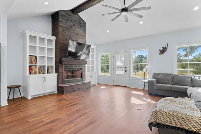 a living room with furniture wooden floor and a fireplace