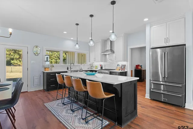 a large kitchen with a table and chairs