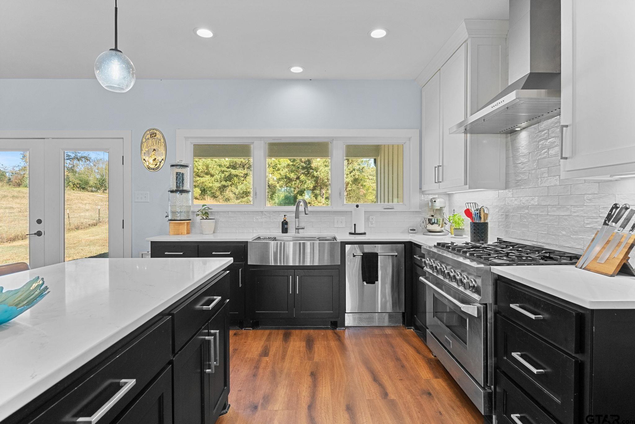 10374 Highway 204 Cushing, TX 75760 - Photo 9 of 28 a kitchen with a stove a sink a window and dining table