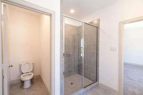 a bathroom with a shower a toilet and a sink