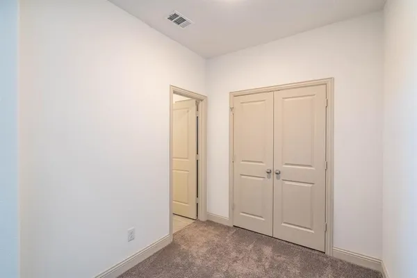 an empty room with closet area