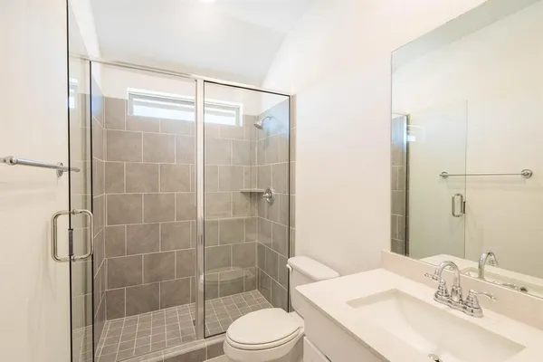 a bathroom with a sink toilet and shower