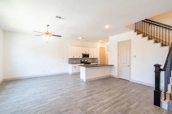 a view of a kitchen with a sink and a refrigerator