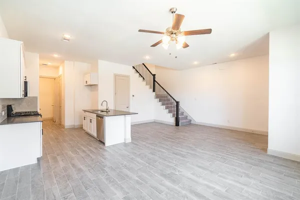 a view of kitchen with sink and wooden floor