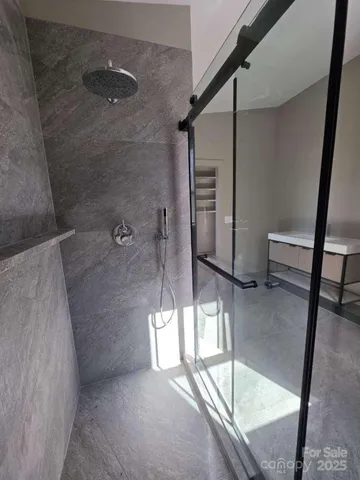 a bathroom with a toilet and a shower
