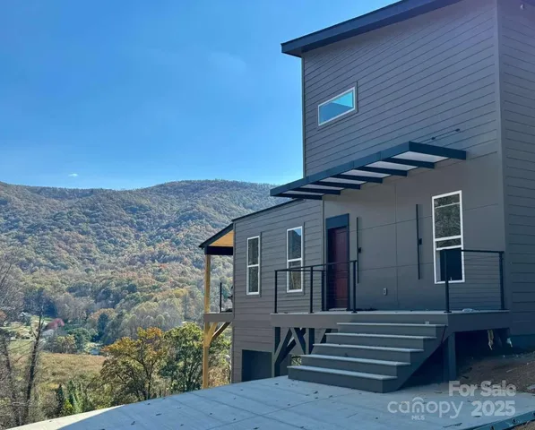 a view of house with roof deck and seating space