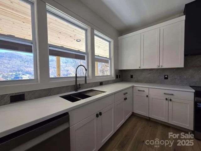 a kitchen with a sink and large window