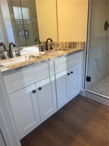 a bathroom with a double vanity sink and mirror