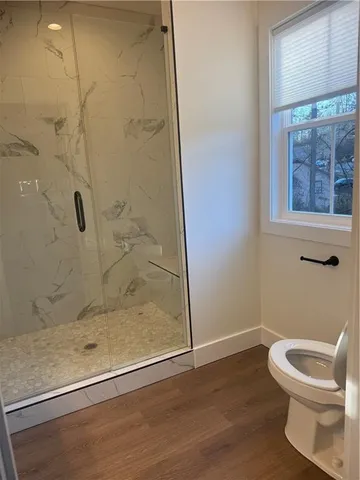 a bathroom with a toilet and a shower