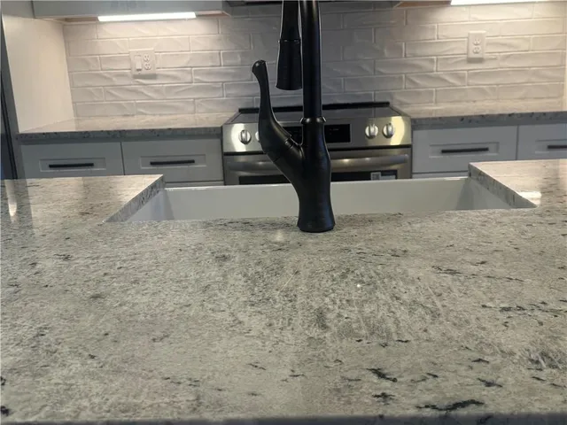 a view of kitchen with granite countertop