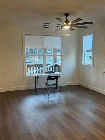 a view of a workspace with furniture and a window