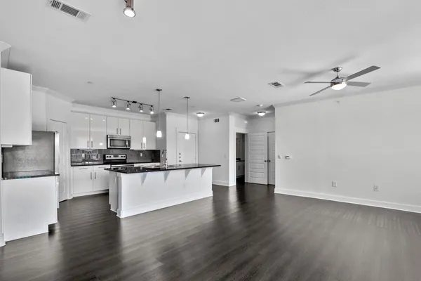 a view of a hall with wooden floor