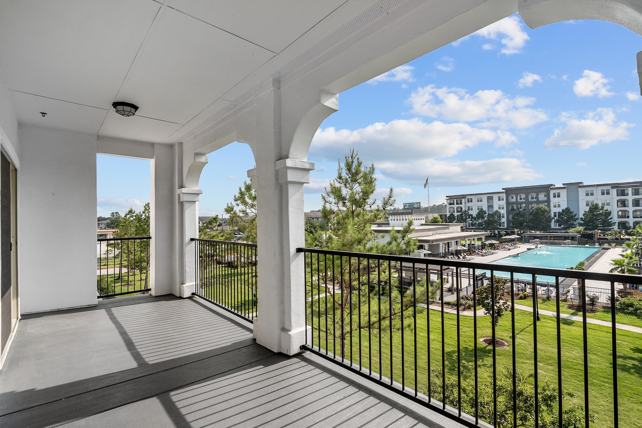 366 Fm 1488 Road, Unit 1249 Conroe, TX 77384 - Photo 15 of 25 a view of a balcony with floor to ceiling windows with wooden floor