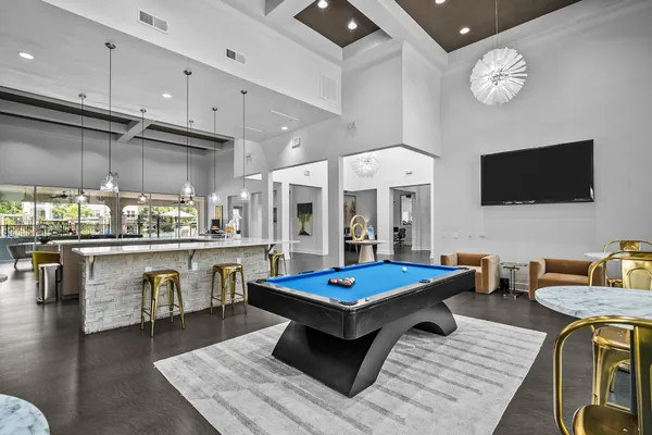 a kitchen with granite countertop a stove a sink a center island with the wooden floor