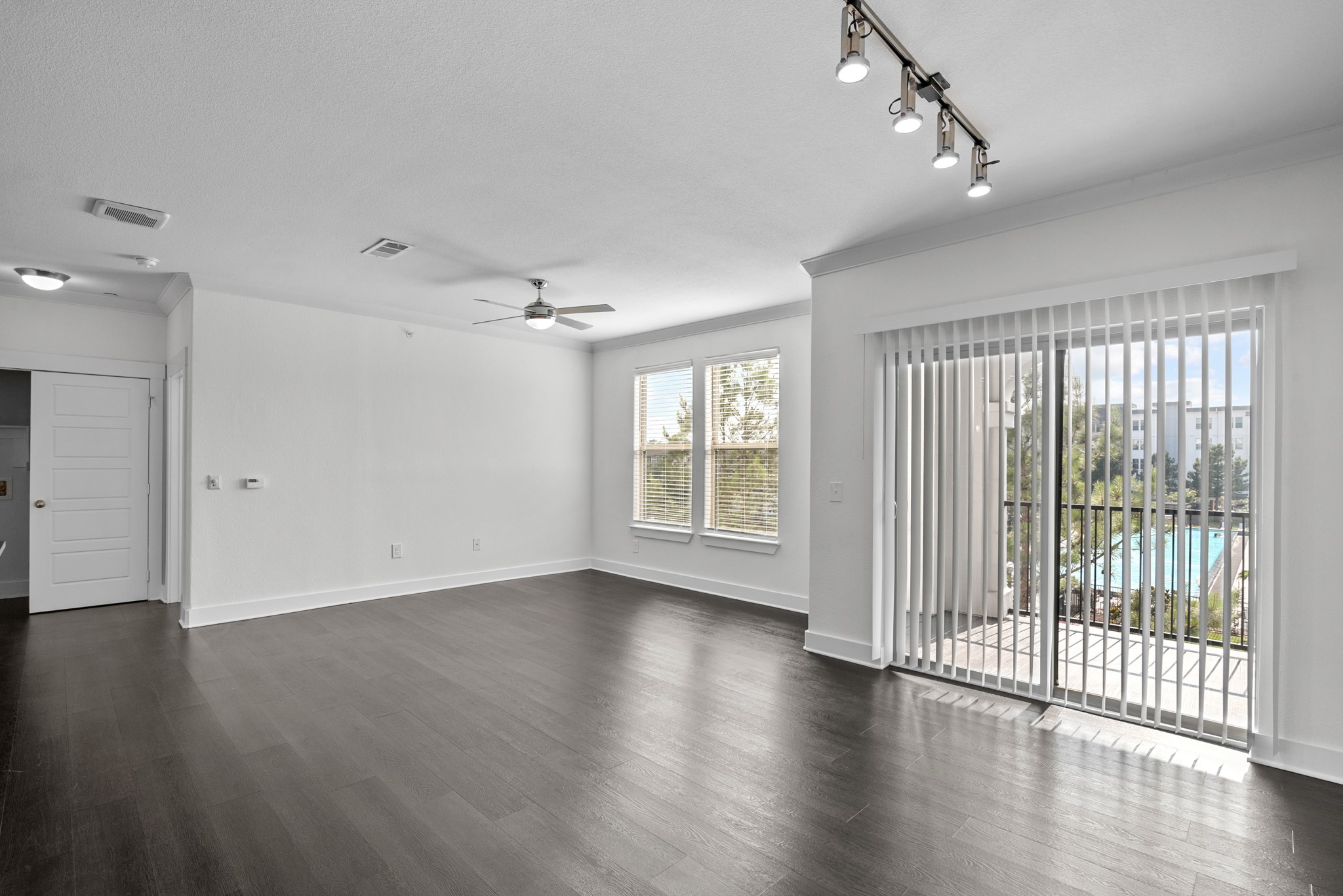 366 Fm 1488 Road, Unit 1249 Conroe, TX 77384 - Photo 3 of 25 a view of an empty room with wooden floor and a window