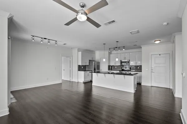 a kitchen with stainless steel appliances granite countertop a refrigerator a sink a stove and cabinets