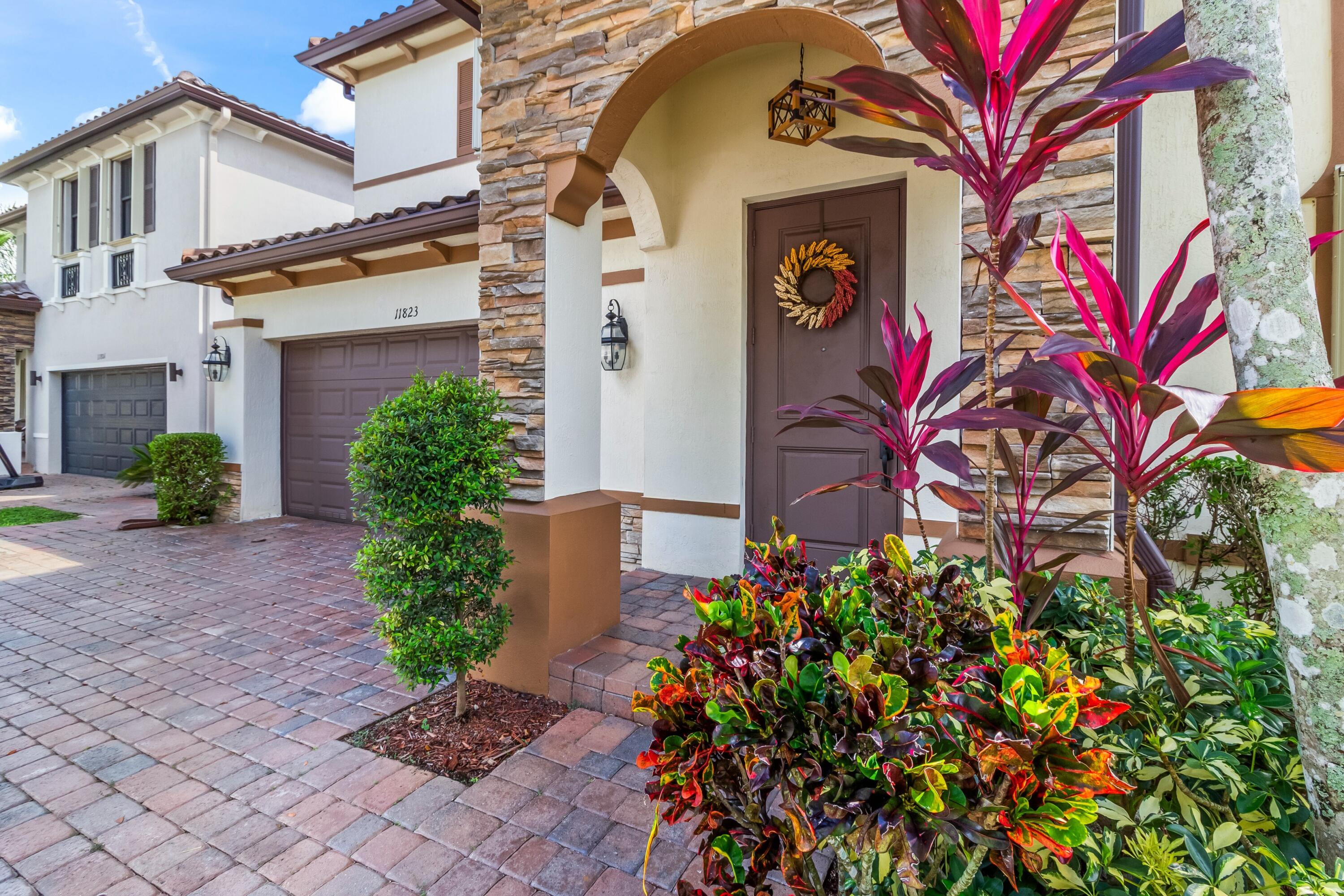 11823 Southwest 151st Place Miami, FL 33196 - Photo 1 of 53 a front view of a house with garden