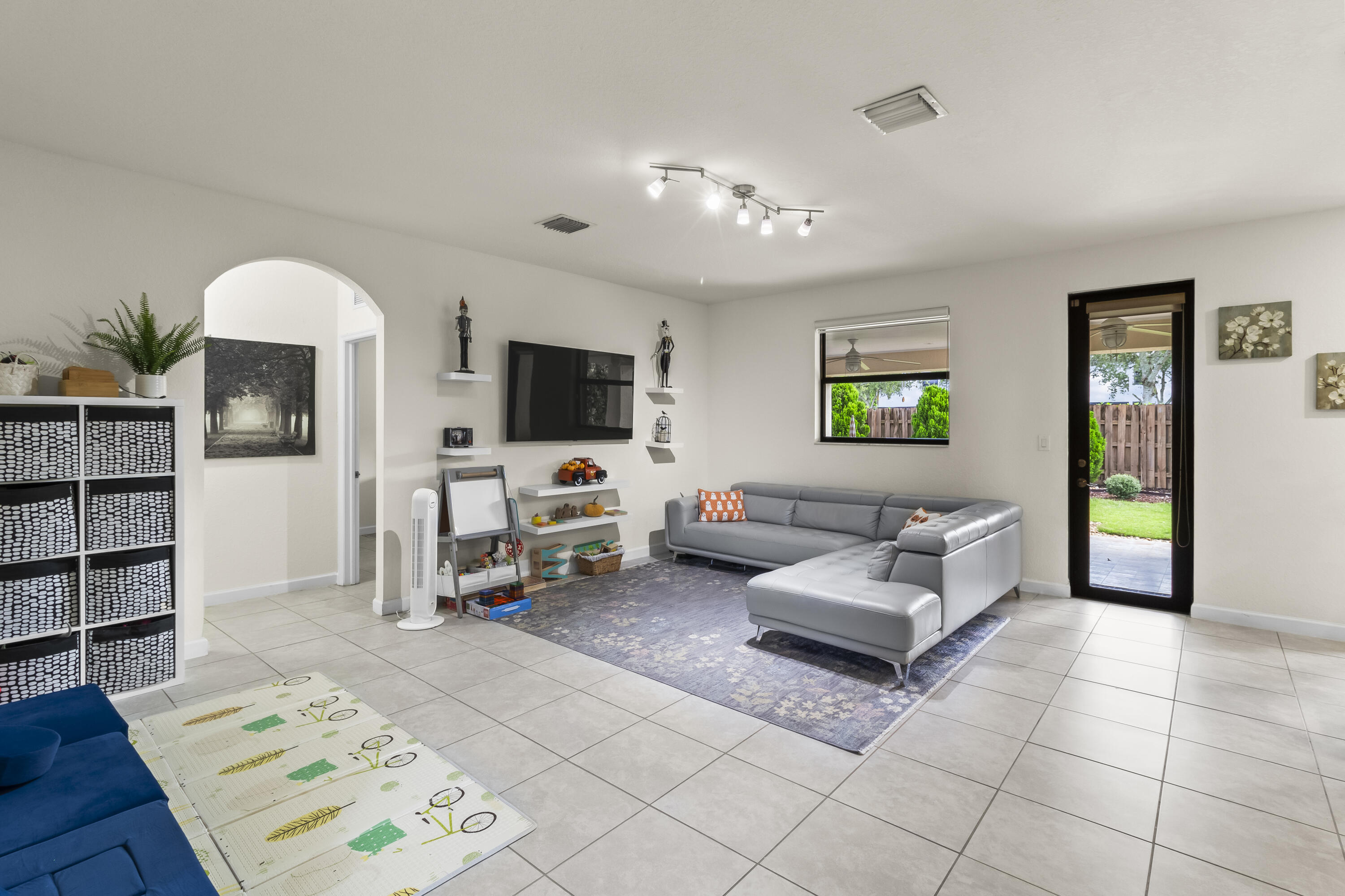 11823 Southwest 151st Place Miami, FL 33196 - Photo 11 of 53 a living room with furniture and a flat screen tv