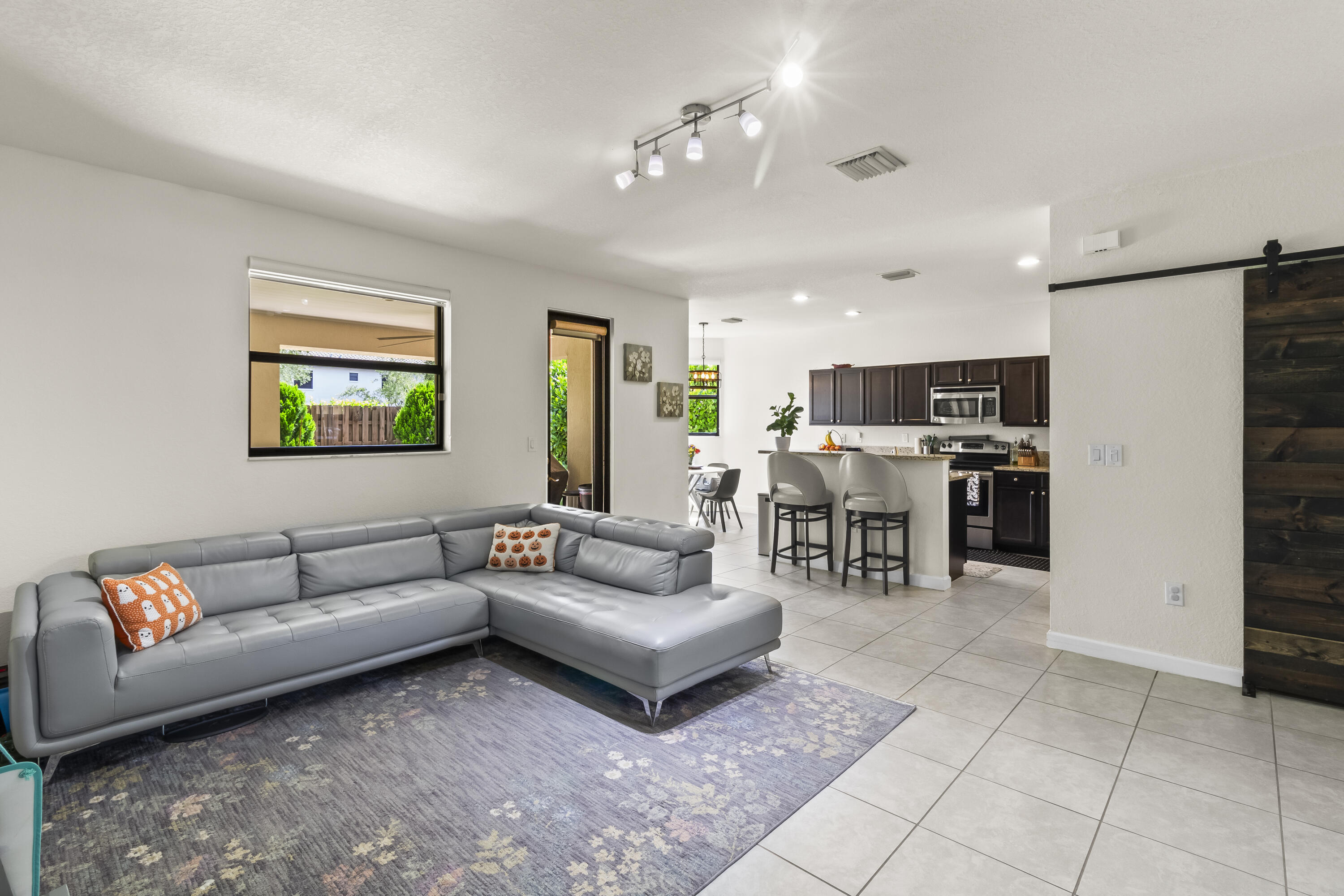 11823 Southwest 151st Place Miami, FL 33196 - Photo 13 of 53 a living room with furniture and a dining table with kitchen view