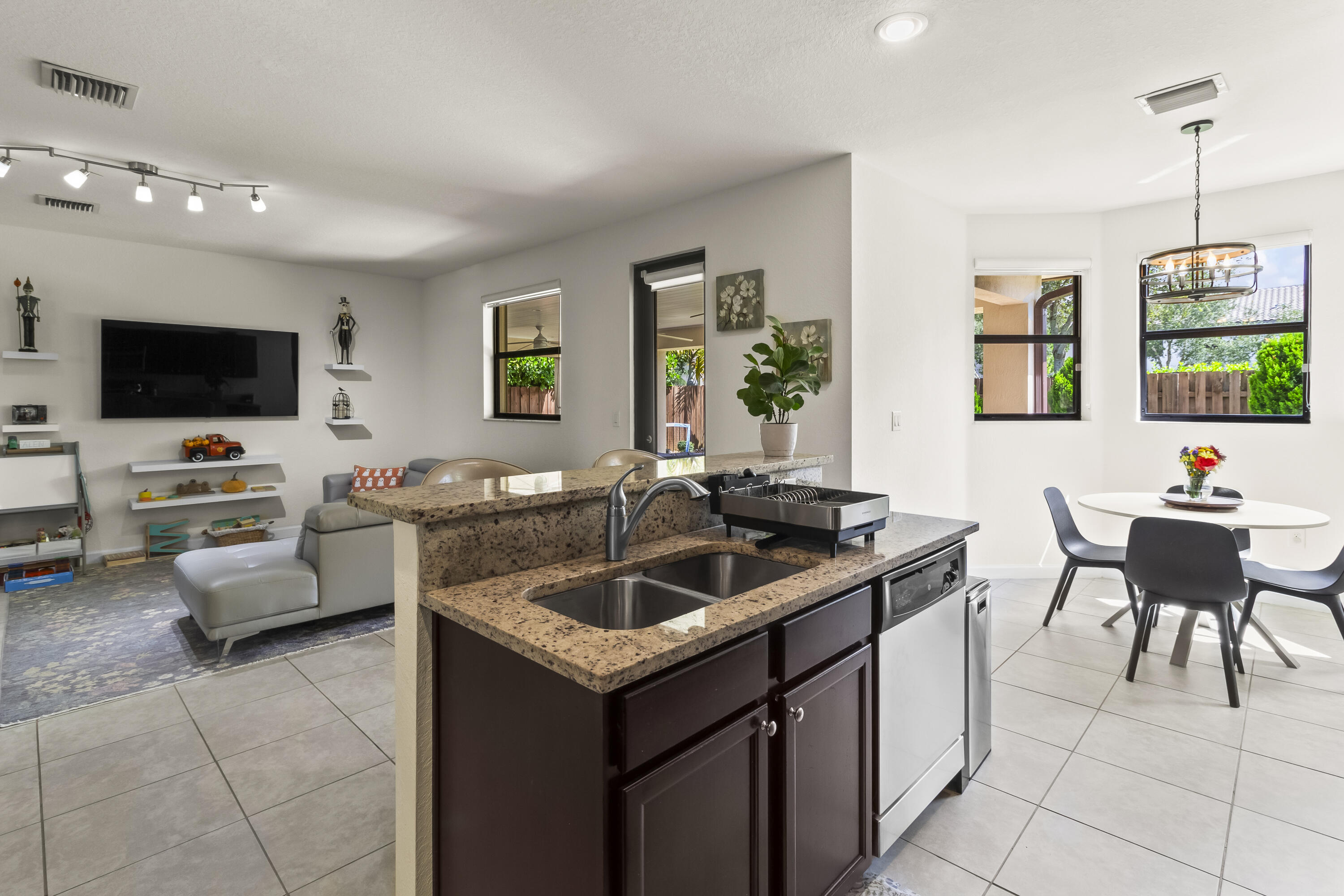 11823 Southwest 151st Place Miami, FL 33196 - Photo 18 of 53 a kitchen with a sink and a stove top oven with wooden floor
