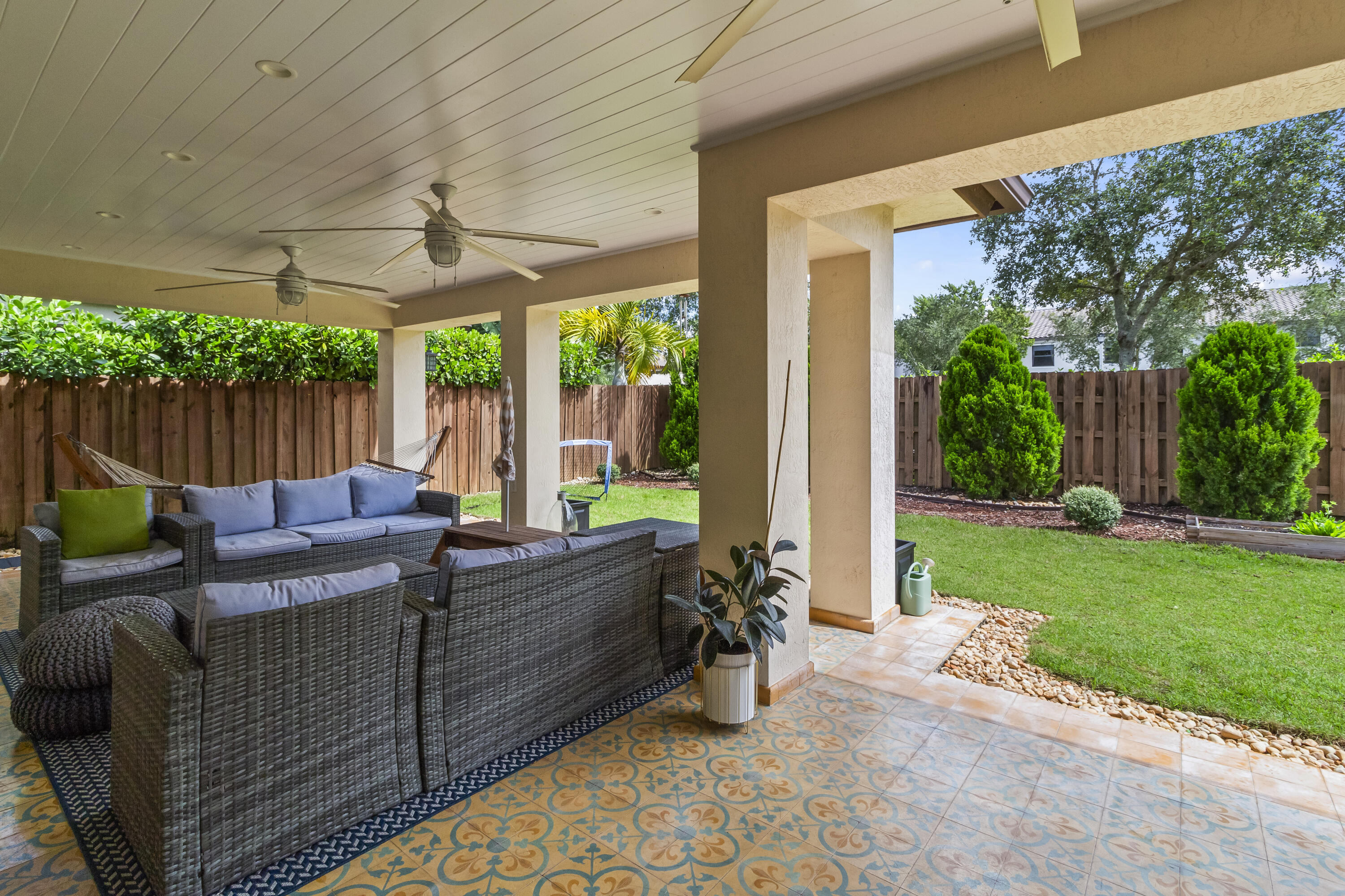 11823 Southwest 151st Place Miami, FL 33196 - Photo 25 of 53 a living room with patio furniture and a garden