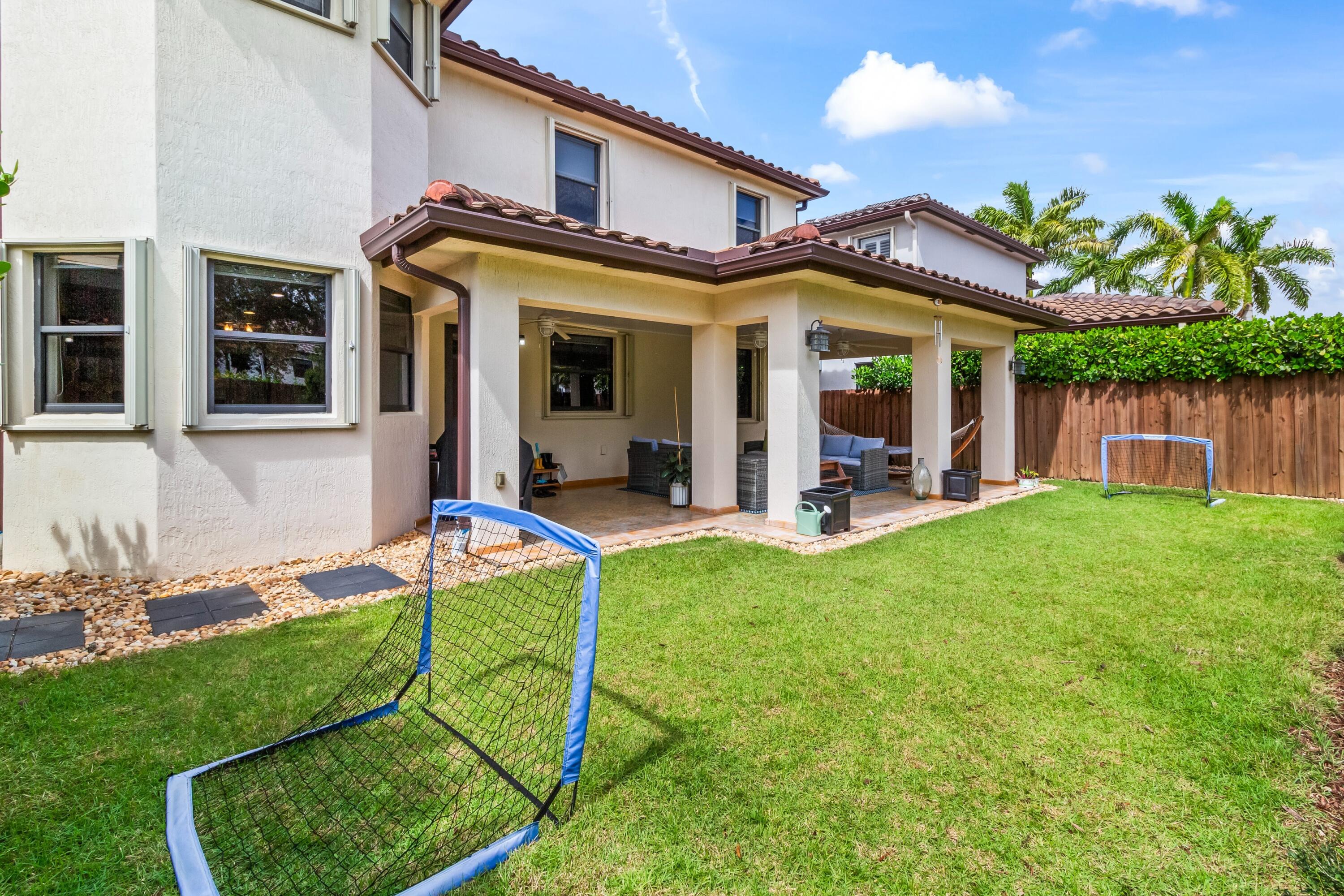 11823 Southwest 151st Place Miami, FL 33196 - Photo 26 of 53 a view of a house with backyard porch and a patio