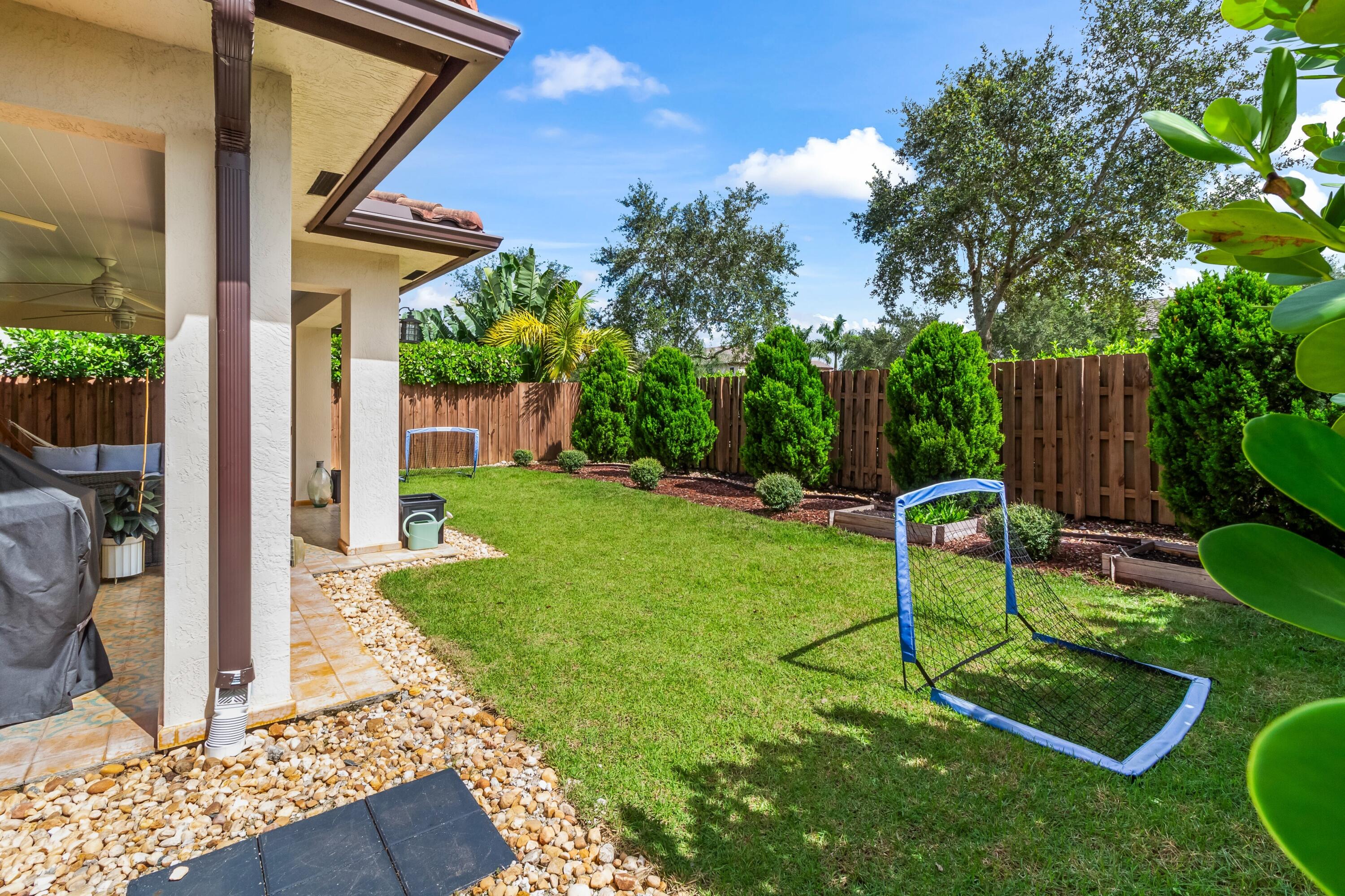 11823 Southwest 151st Place Miami, FL 33196 - Photo 27 of 53 a view of a chair and table in backyard of the house