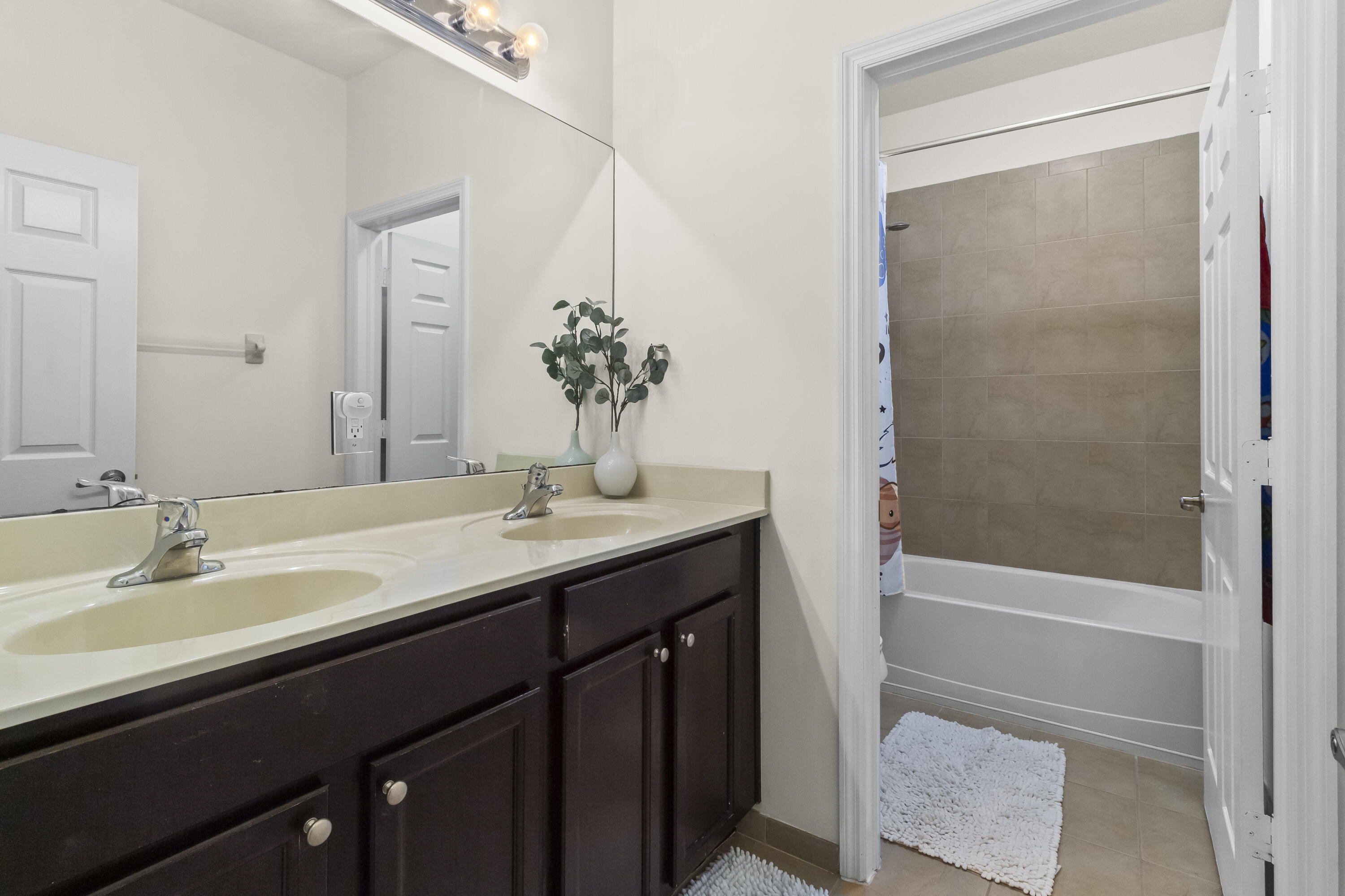 11823 Southwest 151st Place Miami, FL 33196 - Photo 36 of 53 a bathroom with a tub sink and mirror