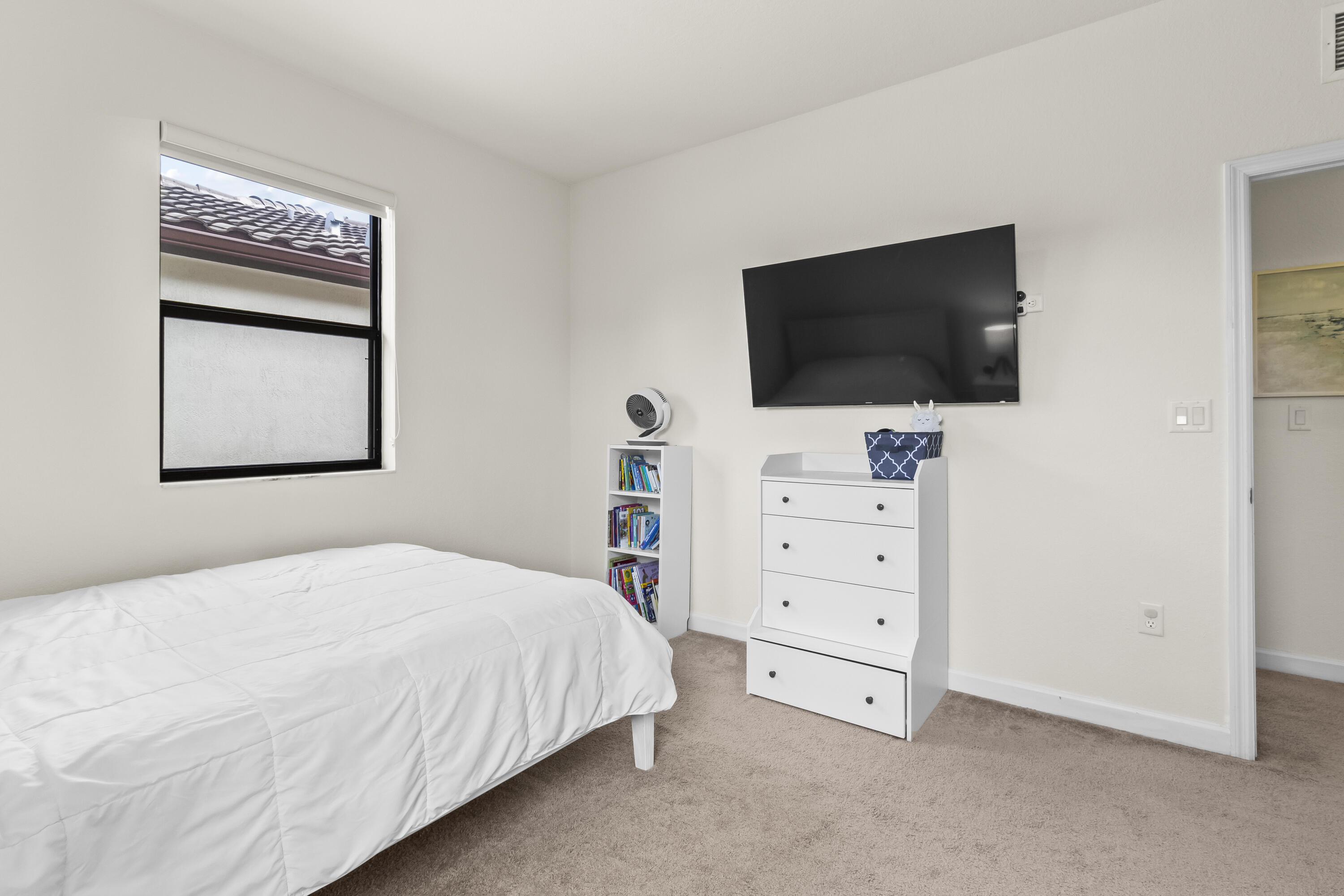 11823 Southwest 151st Place Miami, FL 33196 - Photo 40 of 53 a bedroom with a bed and a flat screen tv