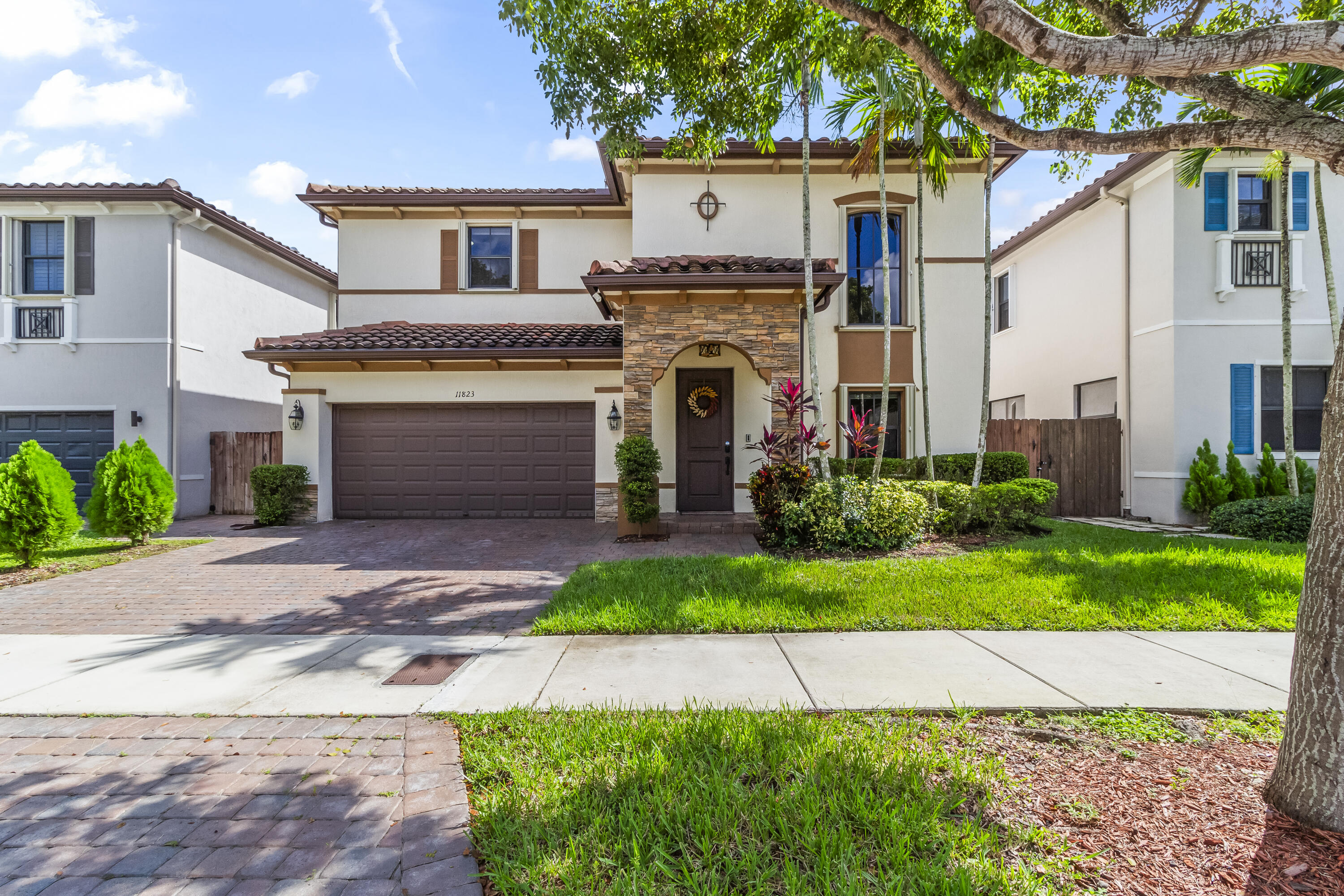 11823 Southwest 151st Place Miami, FL 33196 - Photo 6 of 53 a front view of a house with a garden and plants