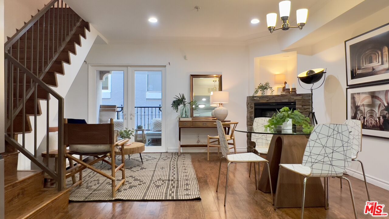 5633 Carlton Way, Unit 203 Los Angeles, CA 90028 - Photo 3 of 15 a living room with furniture dining table a lamp and a chandelier