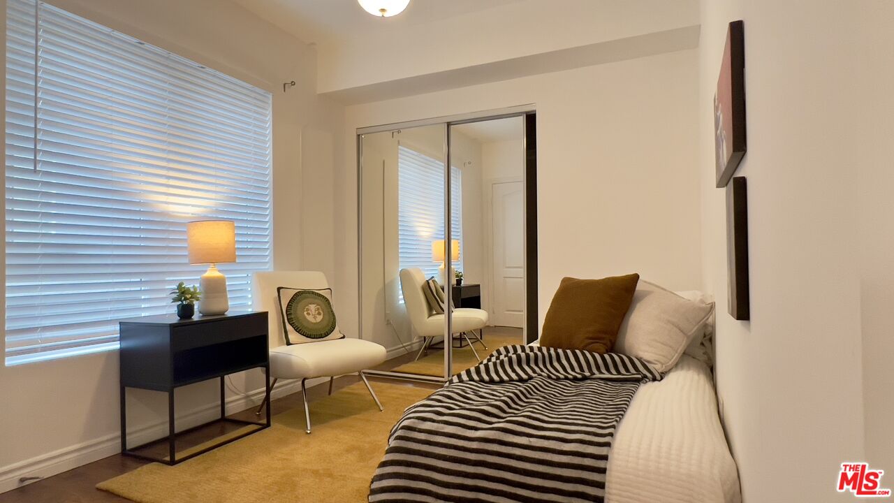 5633 Carlton Way, Unit 203 Los Angeles, CA 90028 - Photo 6 of 15 a bedroom with furniture and a window