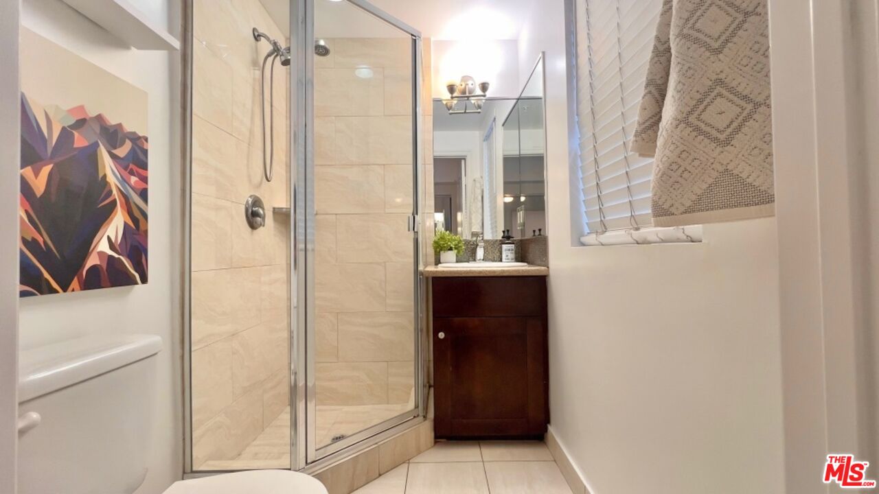 5633 Carlton Way, Unit 203 Los Angeles, CA 90028 - Photo 7 of 15 a bathroom with a shower and a sink