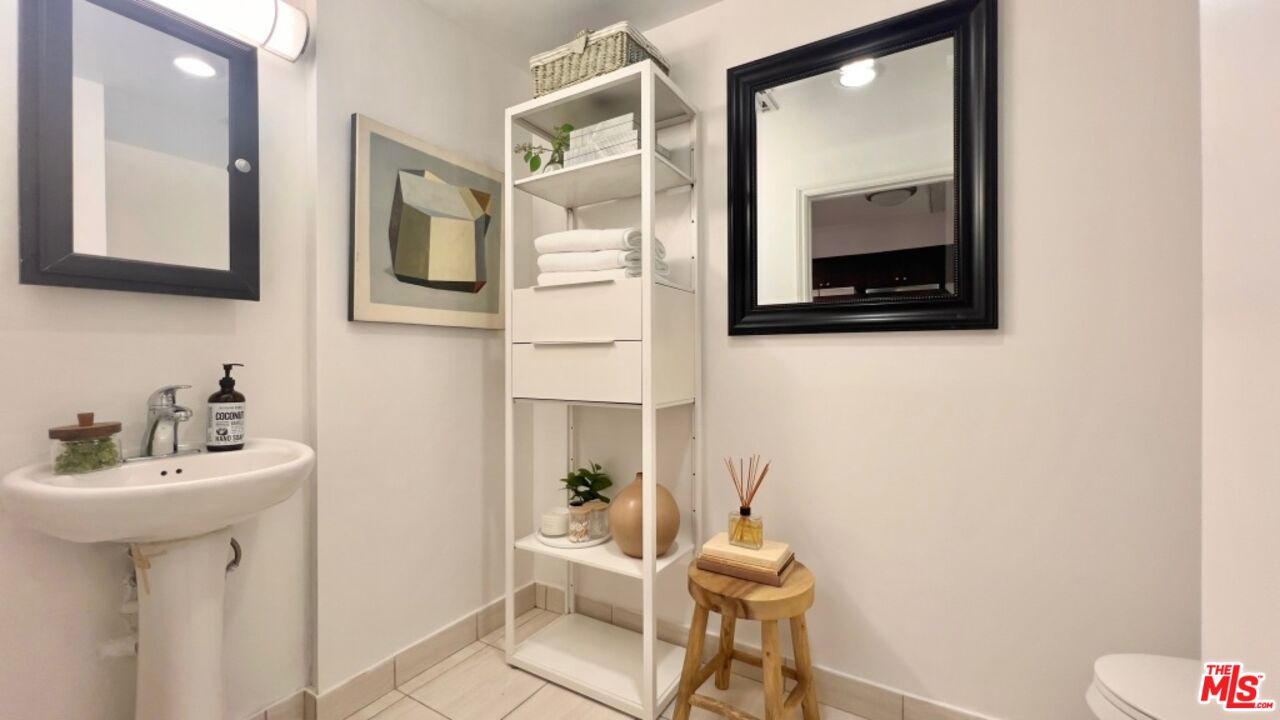 5633 Carlton Way, Unit 203 Los Angeles, CA 90028 - Photo 10 of 15 a bathroom with a sink and a mirror