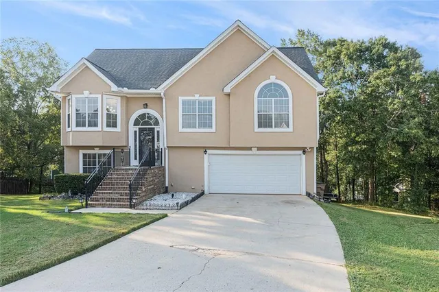 a front view of a house with a yard