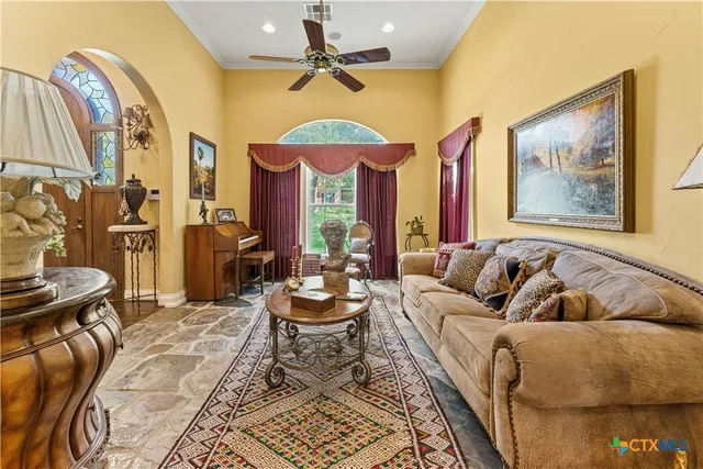 a living room with furniture and a chandelier