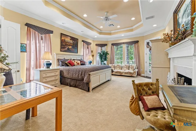 a living room with a bed furniture and a large window