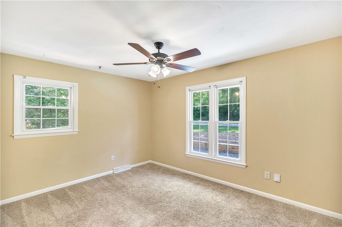 2011 Forest Drive Seneca, SC 29672 - Photo 27 of 36 Well-lit sleeping quarters with dual windows and a ceiling fan.
