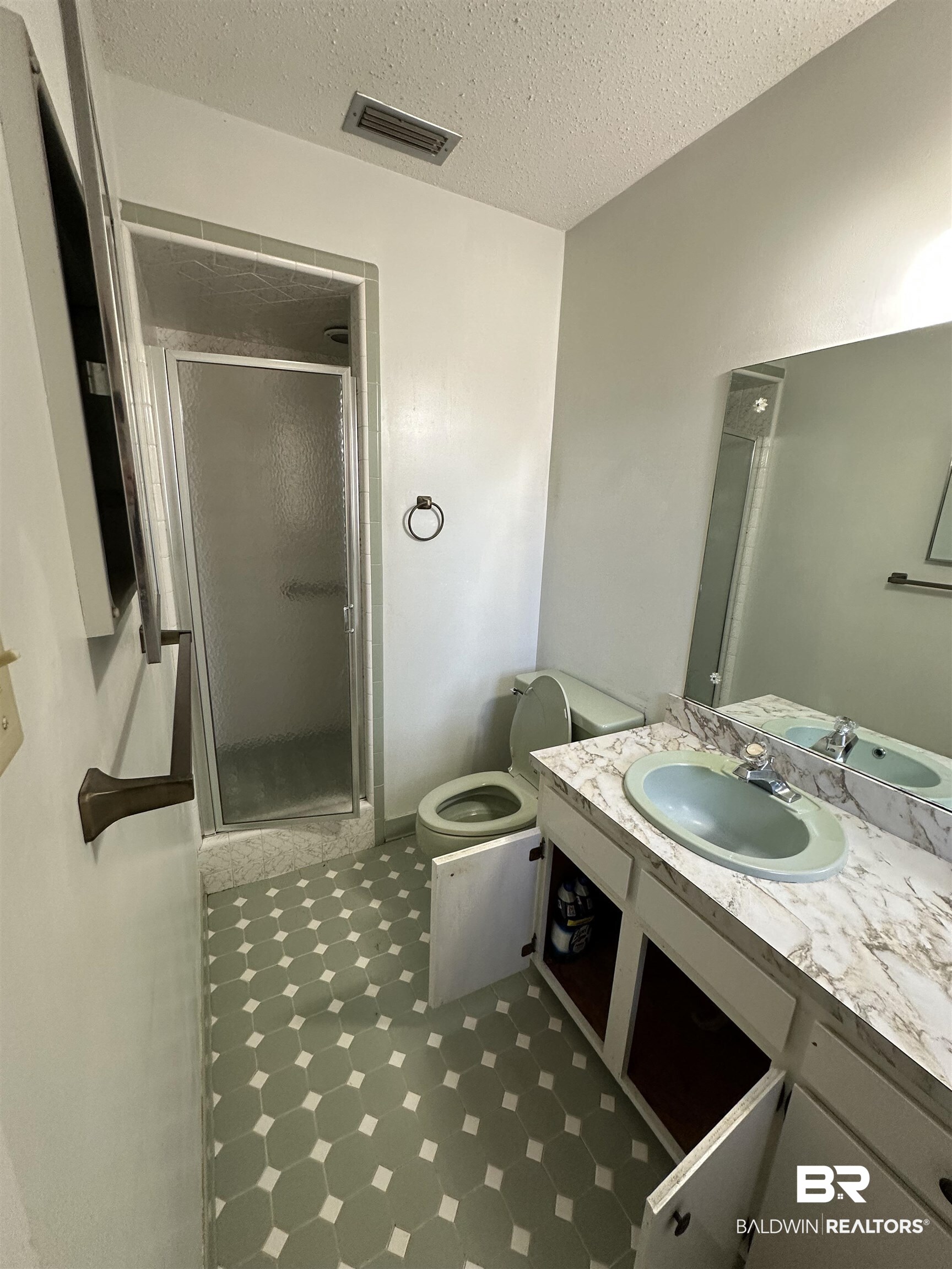 1 Yupon Circle Foley, AL 36535 - Photo 16 of 30 Full bathroom with a shower stall, vanity, light flooring, and a textured ceiling