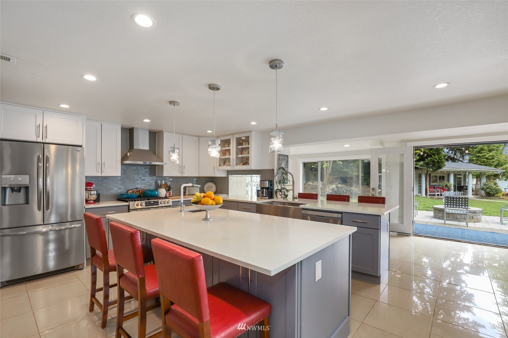 7031 Mullen Road Southeast Olympia, WA 98503 - Photo 16 of 40 a kitchen with a refrigerator a stove a sink a dining table and chairs