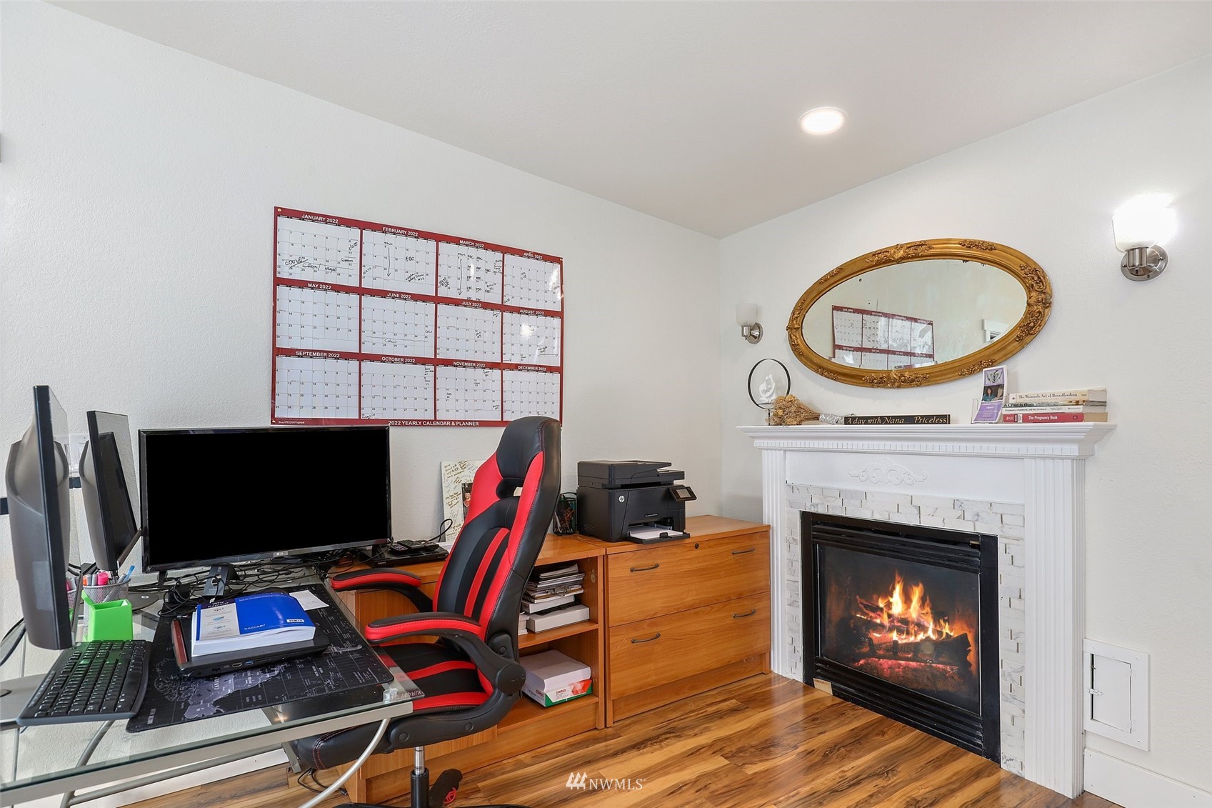 7031 Mullen Road Southeast Olympia, WA 98503 - Photo 22 of 40 a living room with a fireplace a flat screen tv and a fireplace