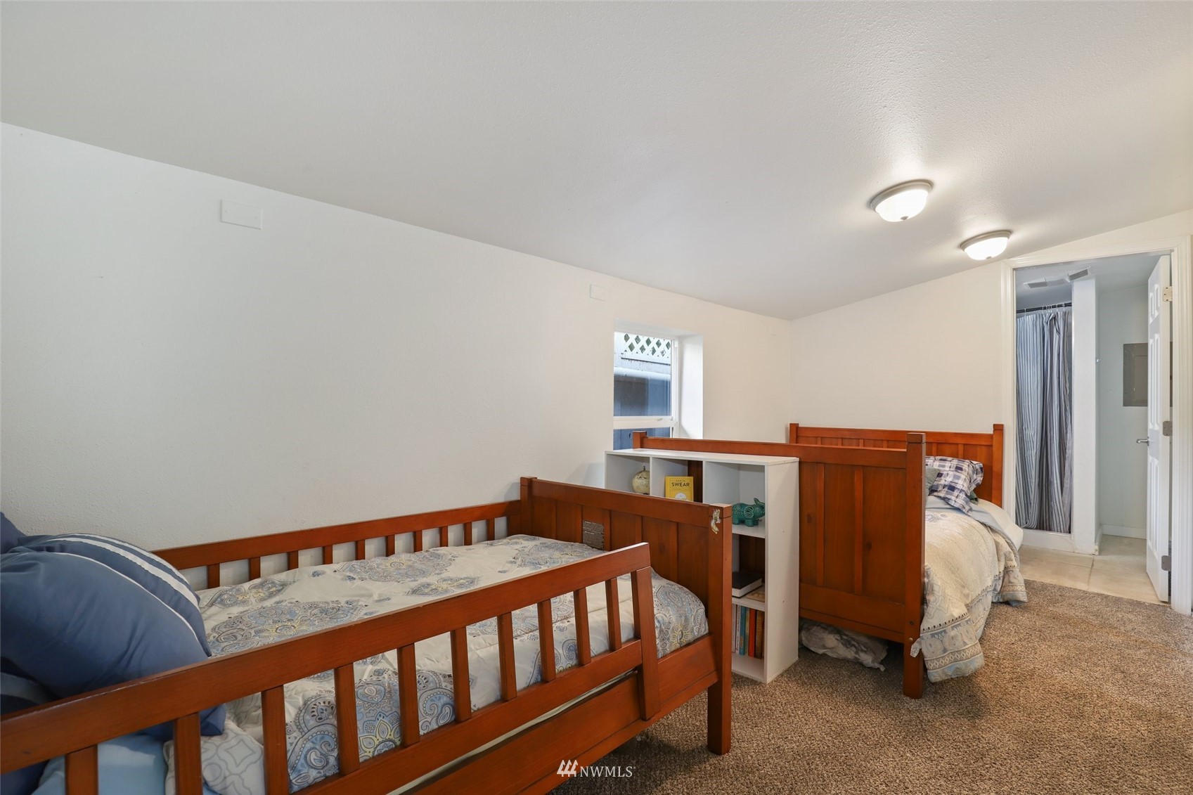 7031 Mullen Road Southeast Olympia, WA 98503 - Photo 29 of 40 a bedroom with a bed and wooden floor