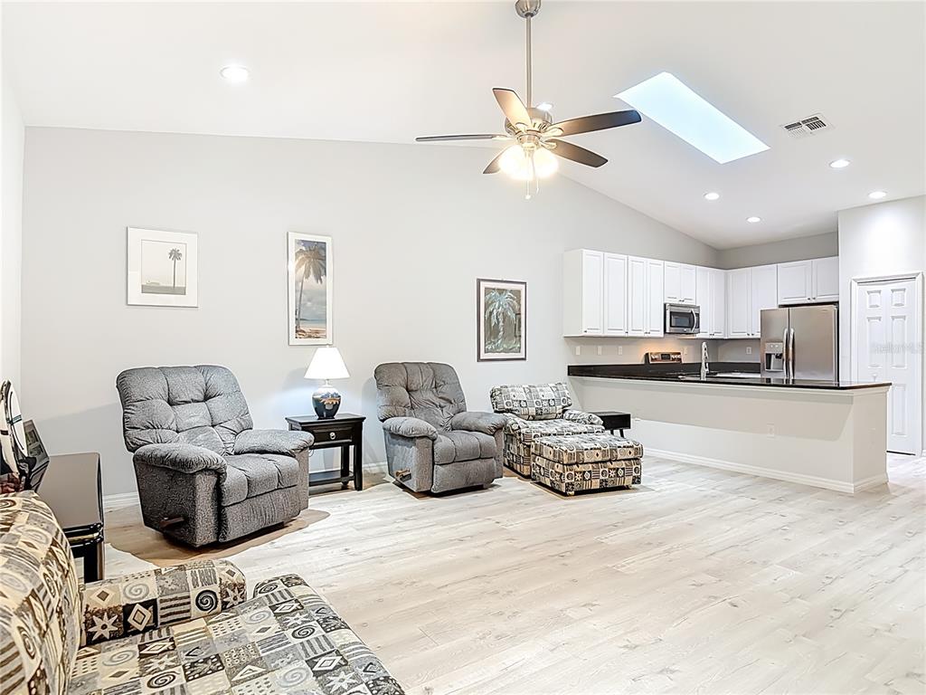 202 Walter Stevens Way DeLand, FL 32724 - Photo 14 of 34 a living room with furniture and kitchen view