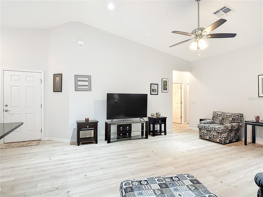 202 Walter Stevens Way DeLand, FL 32724 - Photo 15 of 34 a living room with furniture and a flat screen tv