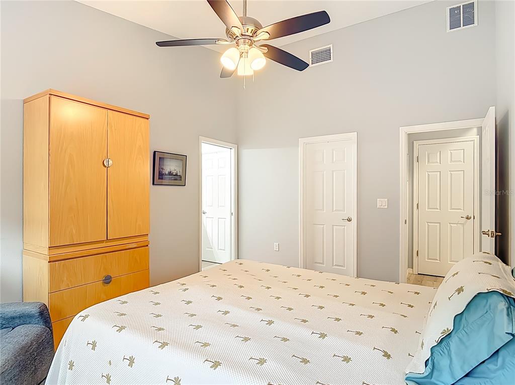 202 Walter Stevens Way DeLand, FL 32724 - Photo 18 of 34 a bedroom with a bed and a chandelier