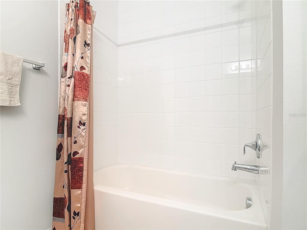 202 Walter Stevens Way DeLand, FL 32724 - Photo 23 of 34 a bathroom with bathtub and shower